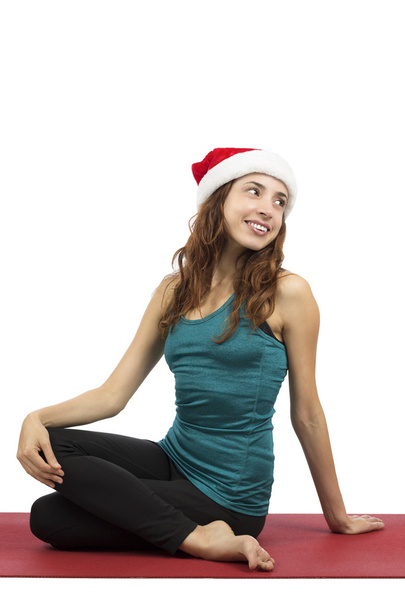 Kerstmis yoga vrouw doen spinal twist - Foto, afbeelding