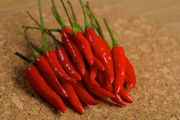 Red hot chilli peppers on a wooden table - Fotoğraf, Görsel