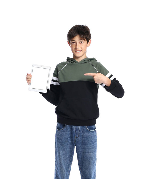Teenage boy pointing at tablet computer on white background - Foto, imagen