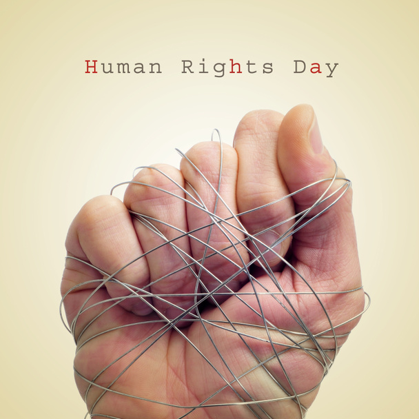 man hand tied with wire and the text human rights day - Photo, Image