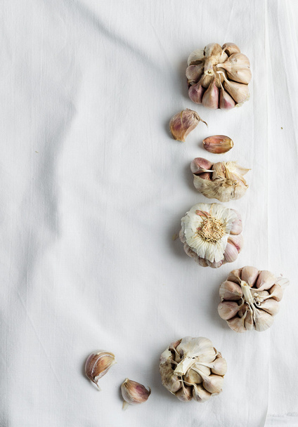 Cloves of garlic over white cloth - 写真・画像