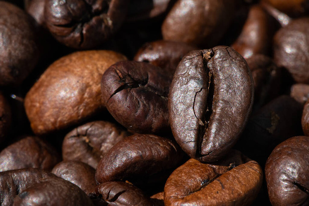 roasted and brown coffee beans background - Fotó, kép