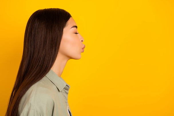 Profile side image of adorable sweet girlfriend go on date with boyfriend give him kiss isolated on yellow color background. - Foto, afbeelding