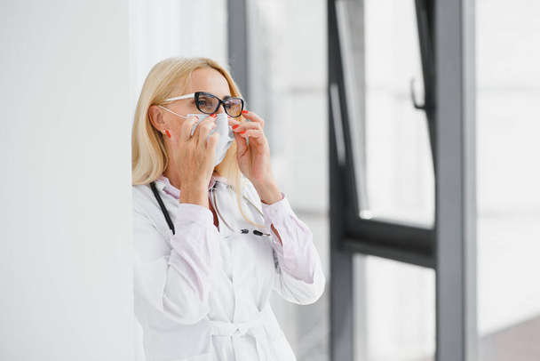 Successful mature caucasian senior female doctor in white coat at hospital - Fotografie, Obrázek