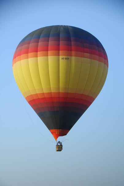 Hot Air Balloon floating over the desert sand - Photo, Image