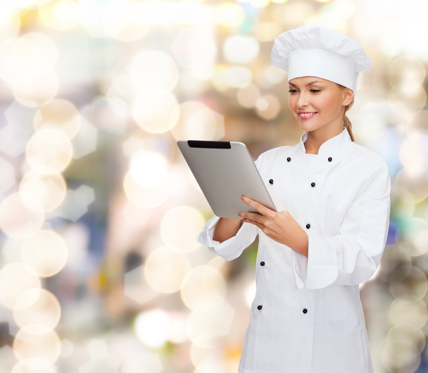 smiling female chef with tablet pc computer - Photo, image