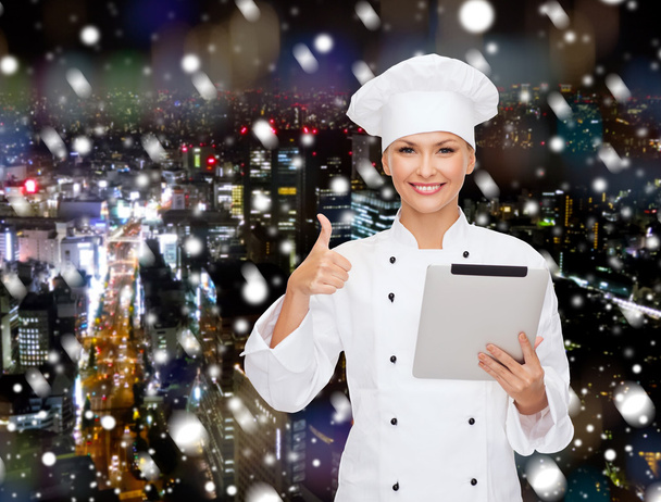 smiling chef with tablet pc showing thumbs up - Foto, Imagem