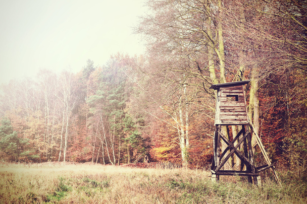 Retro filtered photo of a hunting pulpit in forest. - Photo, Image