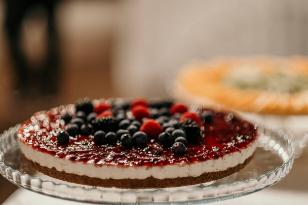 A closeup of a cheesecake with berries - Фото, зображення