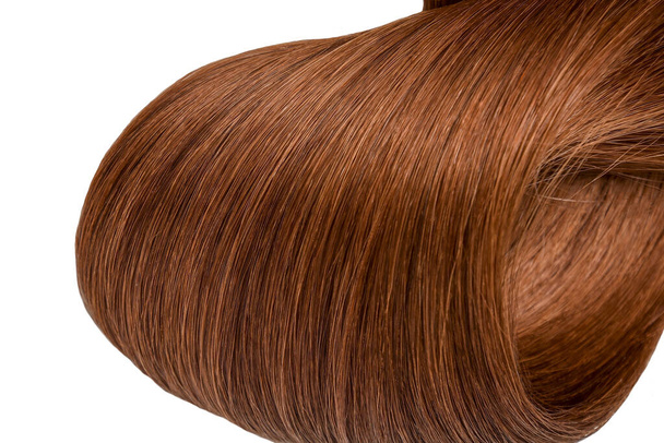 A strand of beautiful, soft and healthy brown and reddish hair isolated on a white background - Valokuva, kuva