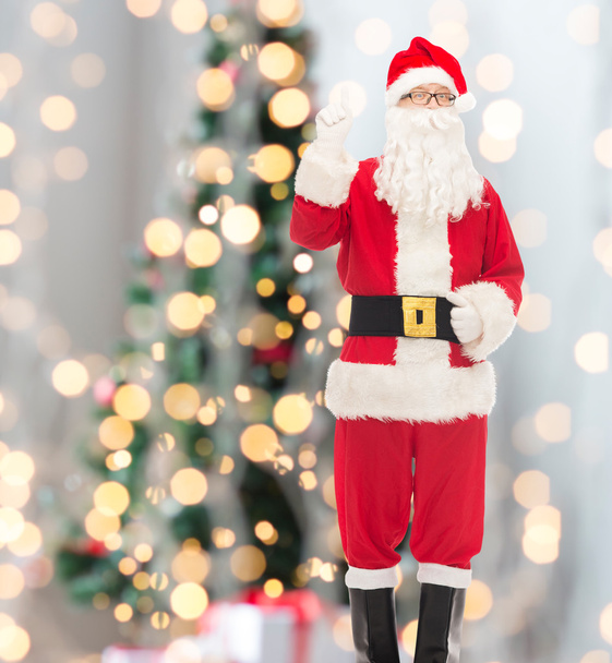 man in costume of santa claus pointing finger up - Photo, image
