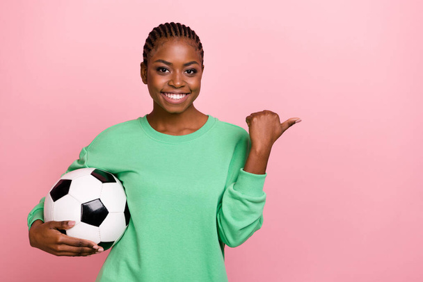 Portrait of positive lady hold football indicate finger empty space isolated on pink color background. - Fotografie, Obrázek