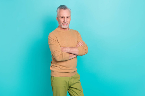 Portrait of calm friendly person folded arms look camera wear sweater isolated on teal color background. - Фото, зображення