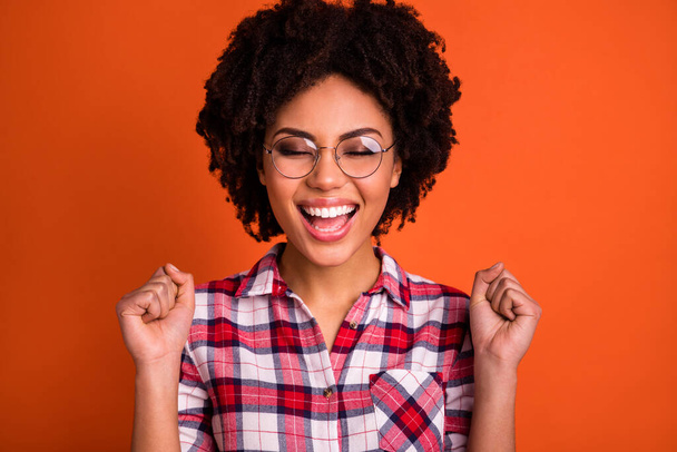 Portrait of cheerful lady fist up celebrate lucky lottery win wear plaid outfit isolated bright color background. - Fotoğraf, Görsel