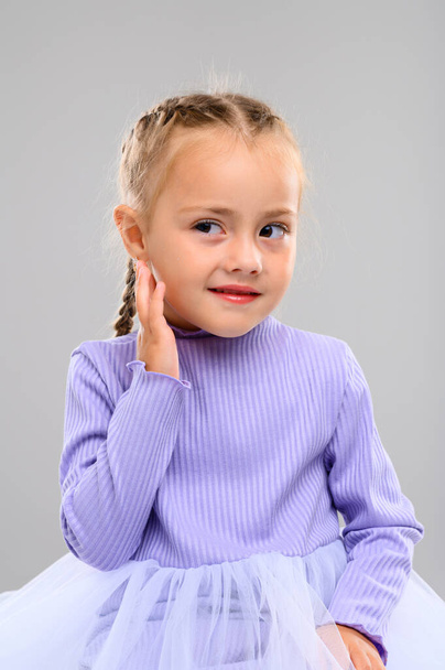 Emotional little girl in the studio on a white background. Portrait - Photo, Image