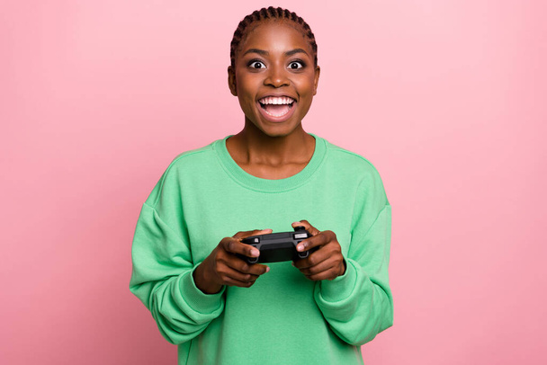 Portrait of positive funky girl hold game pad enjoy playing games isolated on pink color background. - Fotoğraf, Görsel