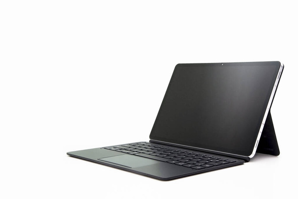 A tablet with a keyboard and black screen isolated on a white background - Foto, Bild