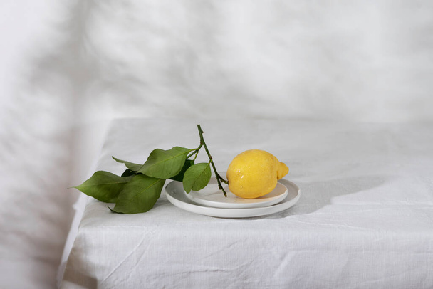 Fresh lemon with green leaves, selective focus image - Foto, afbeelding