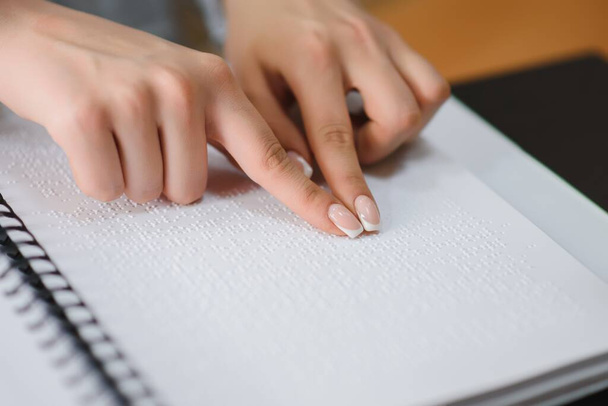 Blind woman read book written in Braille. Close up finger touch to braille Code. - 写真・画像