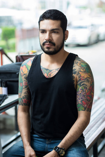 Asian Handsome bearded man. Hipster boy with tattoo. Brutal handsome man with tattooed body - 写真・画像