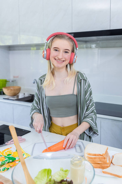 Girl at the kitchen Happy face. Preparing family dinner at home. Happy smiling Girl having fun cooking at kitchen together. Family lifestyle - 写真・画像