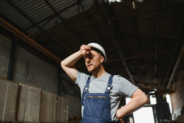 Male warehouse worker portrait in warehouse storage - Fotó, kép