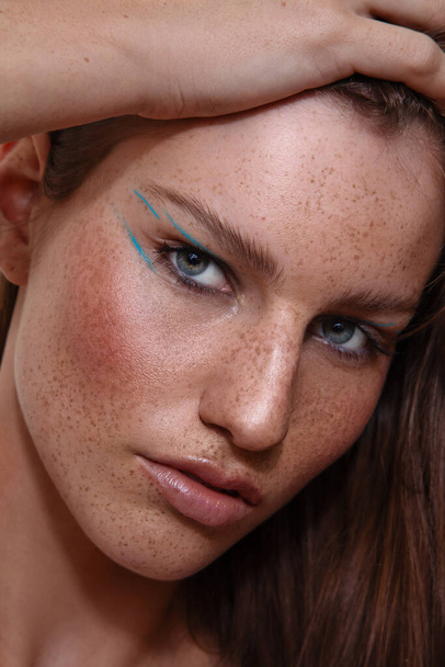 An australian girl with freckles on her face and make up - 写真・画像