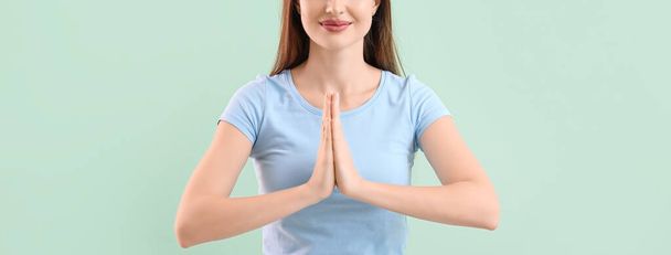 Beautiful woman meditating on color background. Zen concept - Photo, Image