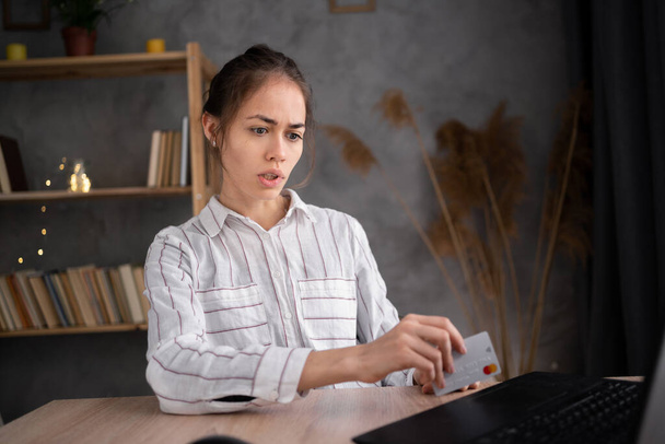 frustrated woman holding credit card rejected online payment having problem paying in internet or debt using computer, failed transaction scam fraud concept - Foto, Bild