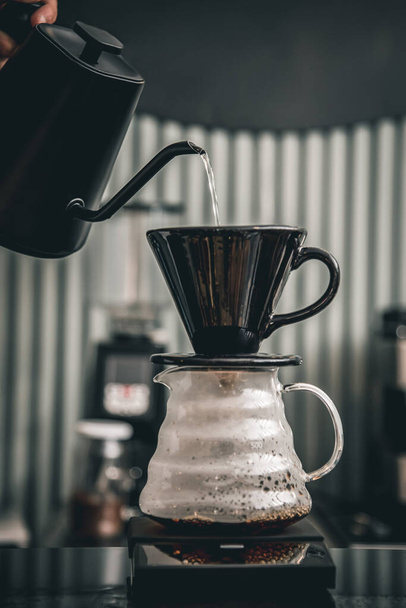 Hot coffee brewed using the drip method with the third generation pour over coffee brewing system - Fotó, kép
