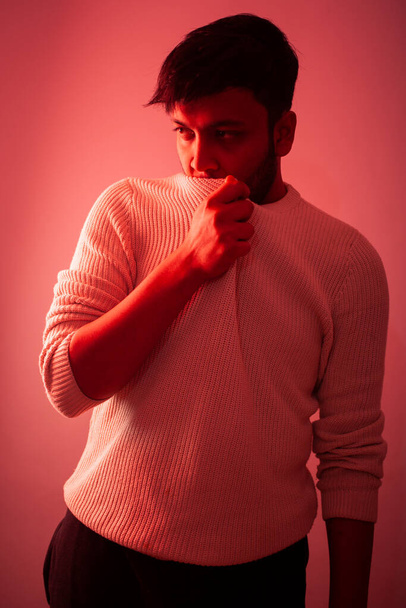Cheerful stylish hipster bearded young indian man fashion portrait with color gel lighting effect - Foto, afbeelding