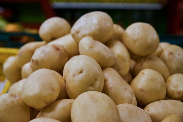 Organic potatoes put on a shelf for sale within a market - Photo, Image