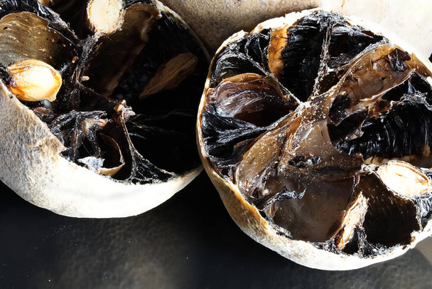 a macro closeup shot of black dried limes for seasoning dishes from Persia, Oman and Arab region - mibu - Fotoğraf, Görsel