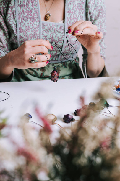 Woman hands making handmade gemstone jewellery, home workshop. Women artisan creates jewellery. Art, hobby, handcraft concept - Fotografie, Obrázek