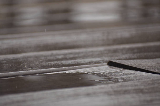 A shallow focus of an old wet wood floor panel background - Foto, Imagem
