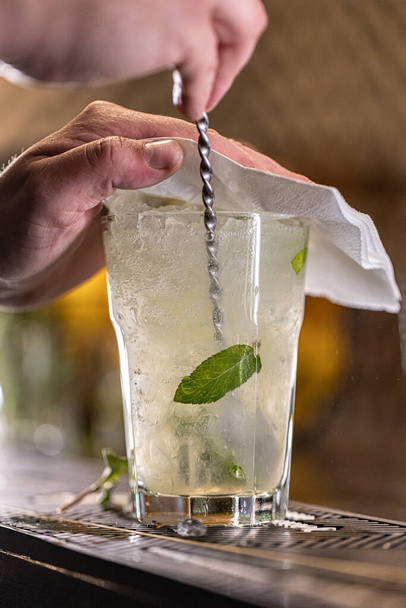 Barman preparing mojito cocktail. Long drink concept - Фото, зображення