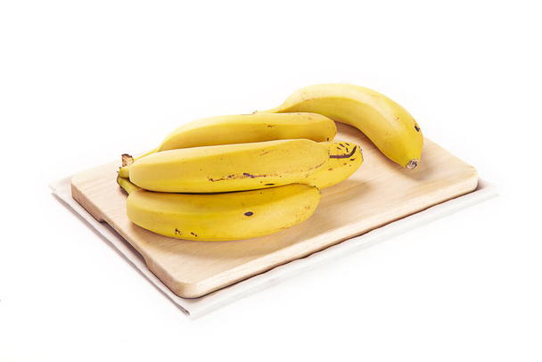 The bananas on the wooden board isolated on a white background - Foto, Imagen