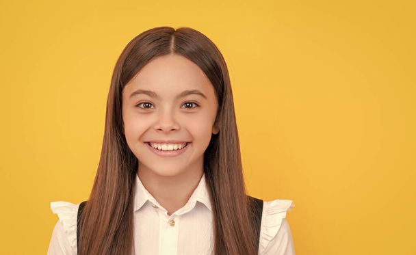 knowledge day. education concept. kid in uniform on yellow background. september 1. childhood. child expressing emotions. cheerful teen girl with long hair. back to school. - Fotografie, Obrázek