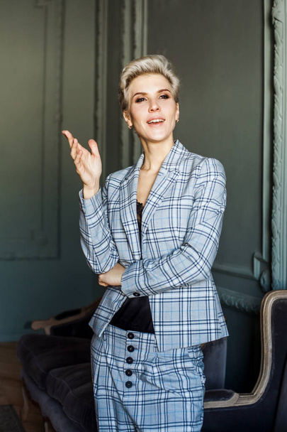 Creative fashioable woman in suit standing indoor - Valokuva, kuva