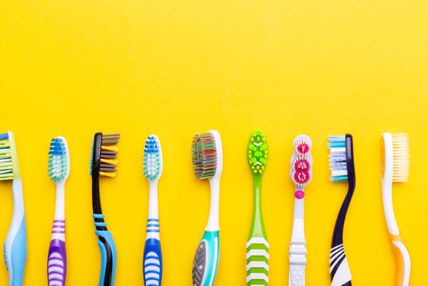 Toothbrushes on a yellow background. Health care, dental hygiene. Space for text. Top view. - Foto, Imagem