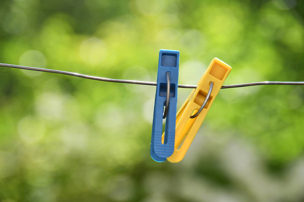 two clothespins hanging on a rope - Fotografie, Obrázek