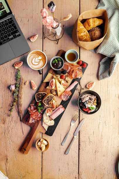 A vertical closeup of the wooden table with various types of food. - Fotó, kép
