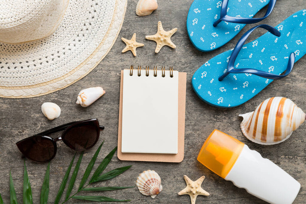 Blank writing book with summer beach accessories on background, copy space. Flat lay with copy space. - 写真・画像