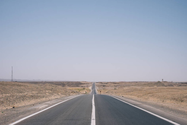 A road through the Sahara desert on a blue sky background in Egypt - Valokuva, kuva