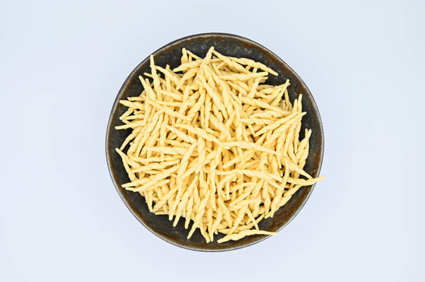 A top view of raw trofie pasta on a white background - Foto, Imagen