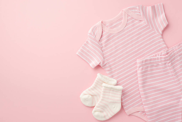 Baby clothes concept. Top view photo of pink shirt shorts and socks on isolated light pink background with copyspace - Foto, Imagen