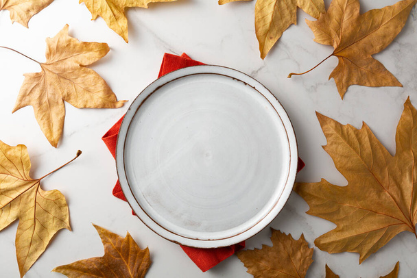 White plate top view and leaves autumn concept - Photo, image