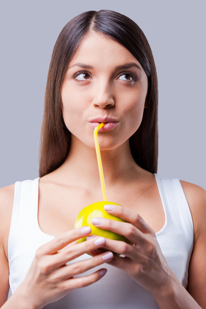 Woman imitating drinking juice from apple - Foto, afbeelding