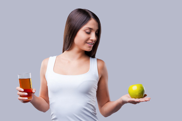 Woman holding apple and glass with juice - Foto, Imagen