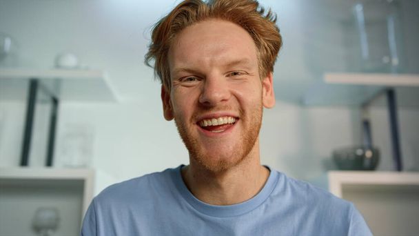 Cheerful man using webcam closeup. Laughing blogger streaming talking at home. Handsome bearded ginger man chatting online with friend on weekend. Happy guy university student enjoying remote class. - Fotografie, Obrázek